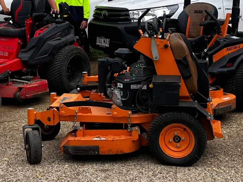 A Triple Sweep commercial stand-on mower, close up