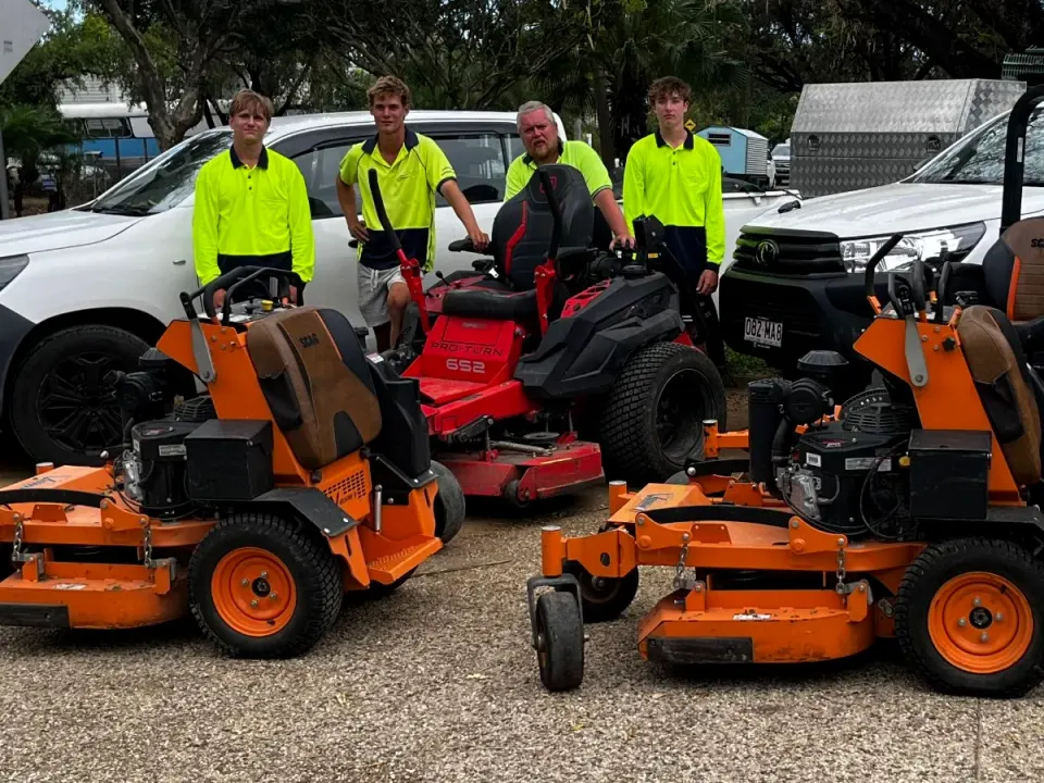 Four Triple Sweep team members behind their commercial mowers